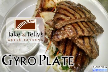 Entrees at Jake and Telly's: Gyro Plate. A close up photo of our Gyro Plate. A succulent blend of specially seasoned lamb and beef, grilled to order. Served with roasted red potatoes, sautéed vegetables and our house-made tzatziki. Jake and Telly’s Logo and the AlphaPixel Reach Logo are present.