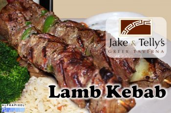 Entrees at Jake and Telly's: Lamb Kebab (Arní Kebabs). A close up photo of our lamb kebab. Colorado lamb skewered with bell pepper and onion and served with herbed rice, butter braised green beans, and our house-made tzatziki. Jake and Telly’s Logo and the AlphaPixel Reach Logo are present.