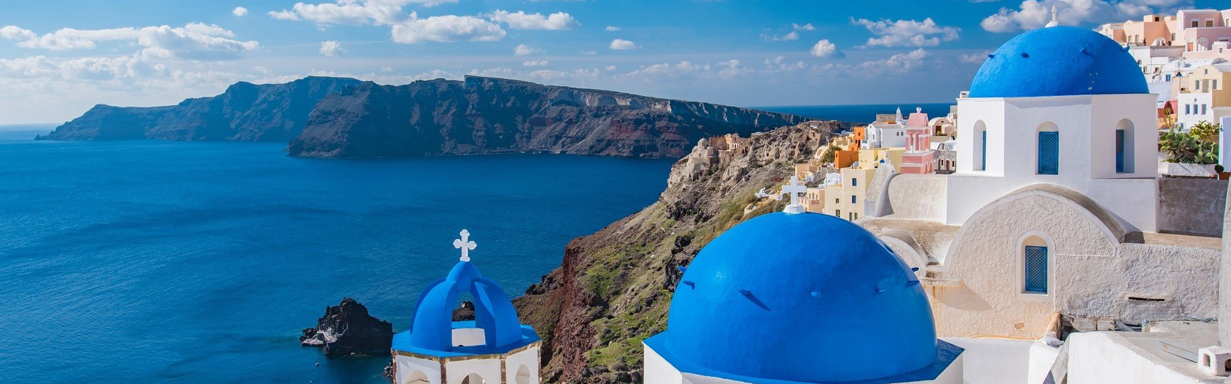 Slider image, Santorini Coast, Blue Domed Greek Churches on cliffs overlooking the ocean