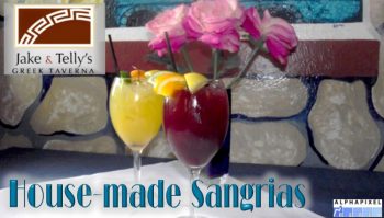 House Made Sangrias: Photo of red and white sangrias in front of pink roses on a blue plate. They are in front of a frescoed wall depicting rocks. A red Jake and Telly's logo is in the upper left, the text "House made Sangrias" is in the lower left, and the Alphapixel Reach logo is in the lower right corner.