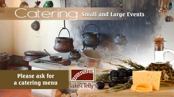 Photo ad for Jake and Telly's Catering, small and large events, please ask for a catering menu. Photo featuring cast iron pot belly pots in an antique Greek Kitchen with images of Olive oil, cheese, black olives and fresh rosemary branches